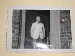 <p>The owner of the row of stores on town square watching behind the scenes action from the back door of the drug store.</p>